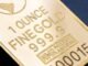 Detailed close-up of a 1 ounce fine gold bar with inscriptions, ideal for finance and investment themes.