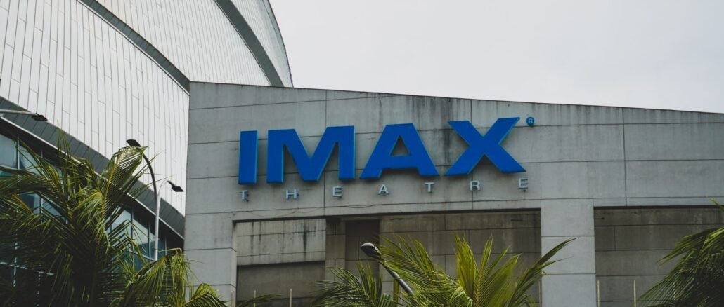 Exterior view of IMAX Theatre in Pasay City, Philippines with palm trees.