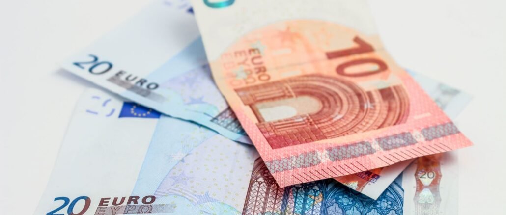 Stack of 10 and 20 euro banknotes symbolizing finance and economy.