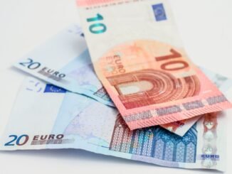 Stack of 10 and 20 euro banknotes symbolizing finance and economy.