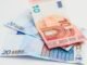 Stack of 10 and 20 euro banknotes symbolizing finance and economy.