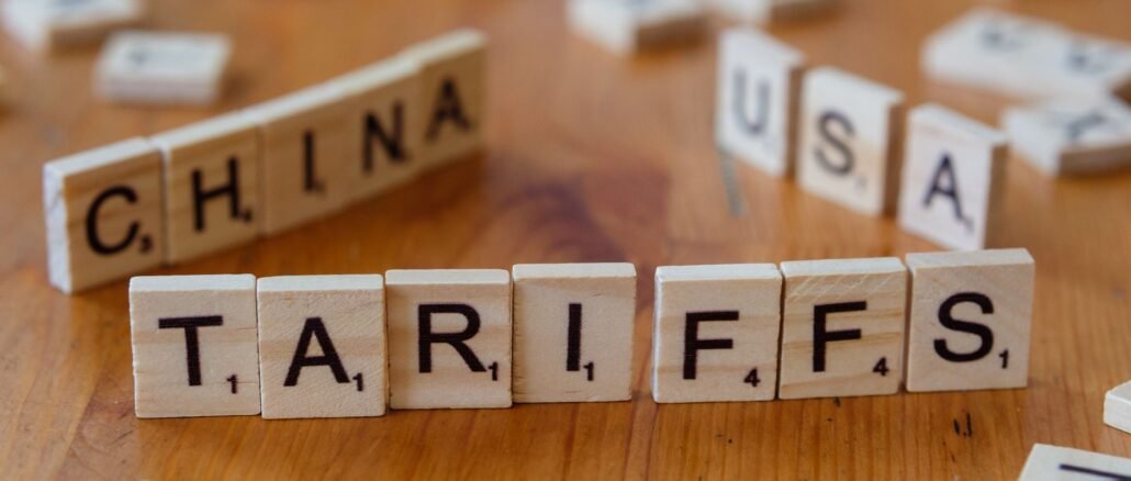 Wooden letter blocks spelling tariffs, China, and USA representing trade relations.