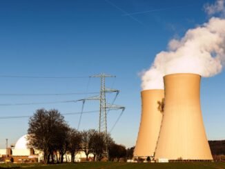 A nuclear power plant in Hameln, Germany, showcasing cooling towers and electricity pylons.