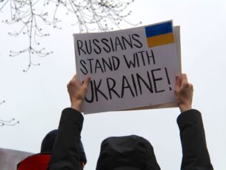 Protesters in Vancouver hold signs supporting Ukraine against Russian actions.