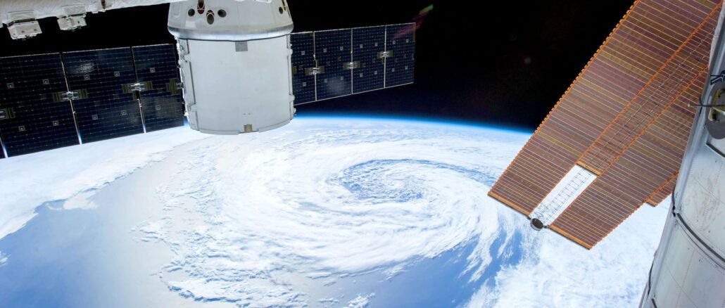 A mesmerizing view of Earth as seen from a space station with solar panels and satellite modules.