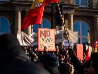 Crowd in Stuttgart demonstrating against AfD with signs and banners.
