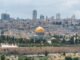 Captivating aerial view of the Dome of the Rock with Jerusalem's skyline in the background.