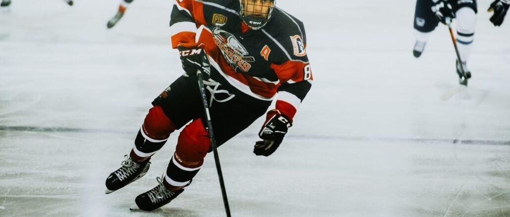Dynamic action shot of a hockey player skating on an ice rink during a game.