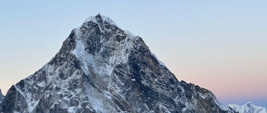 Snow-capped peak in the Himalayas, Nepal, captured during a serene sunset.