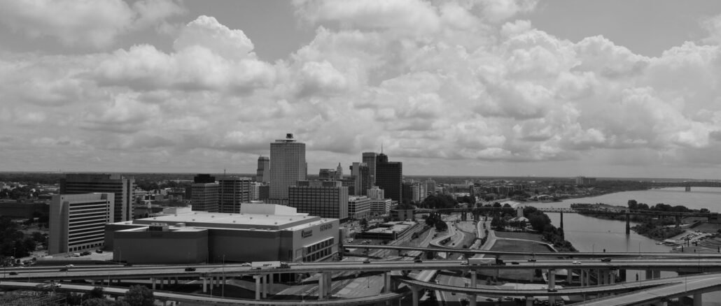 Aerial view of Memphis skyline with highways and river in black and white.