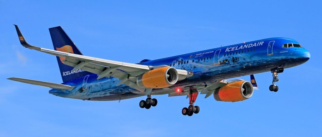 Icelandair airplane in flight against blue sky, showcasing vivid colors and design.