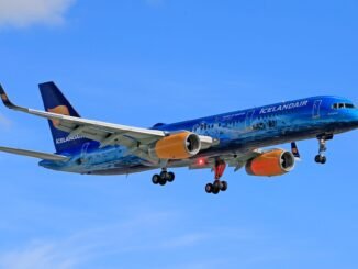 Icelandair airplane in flight against blue sky, showcasing vivid colors and design.