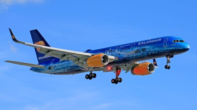 Icelandair airplane in flight against blue sky, showcasing vivid colors and design.