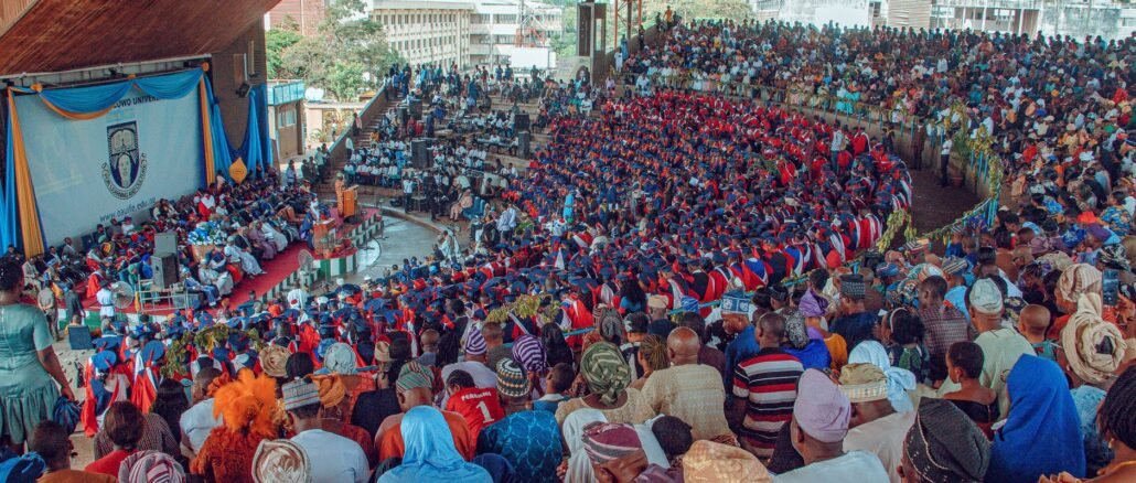 Large audience at a graduation ceremony in Ife, Nigeria, showcasing cultural diversity and academic celebration.