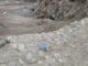A landscape showing mud, debris, and a lone boot in Mocoa, Colombia's natural disaster aftermath.